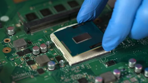 Technician plug in CPU microprocessor to motherboard socket Video stock 61635110