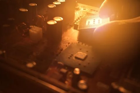 Technician plug in CPU microprocessor to motherboard socket Stock Photos