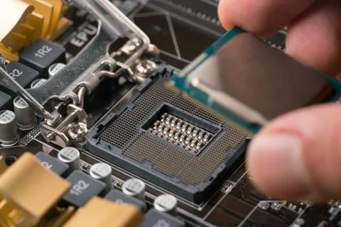 Technician plug in CPU microprocessor to motherboard socket 스톡 사진