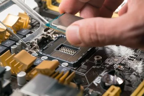 Technician plug in CPU microprocessor to motherboard socket 스톡 사진