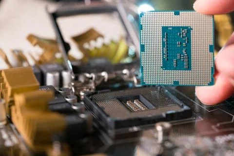 Technician plug in CPU microprocessor to motherboard socket Stockfoto's