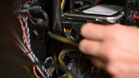 Technician is plugging cables wires from hard drive inside PC personal computer Stockbeeldmateriaal 91224552