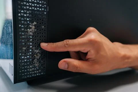 Technician pointing at thick layer of dust on computer air vents, emphasizing Stock Photos