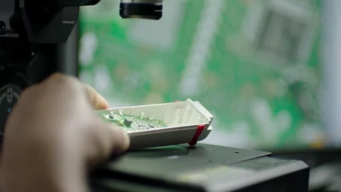 Technician Positions Electronic Circuit Board Under Microscope for Lab Inspectio Stock Footage 334053610