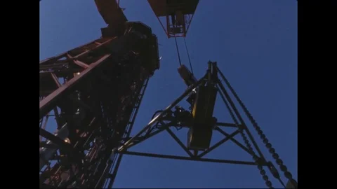 Technician prepares to attach hooks to Agena on transporter - 1965 Stock Footage 101919857