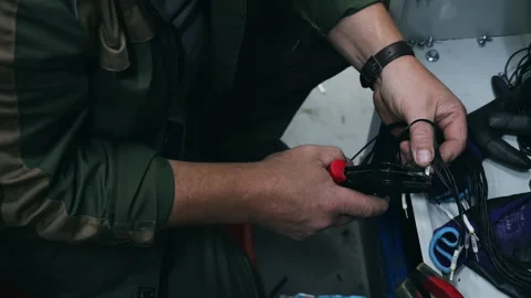 Technician Preparing Electrical Wires with Hand Tool for Installation Видео 345012542