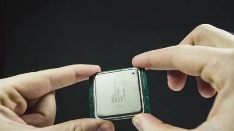 Technician presenting microprocessor on black background 库存影片 295185758