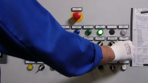 Technician presses keys and turn levers on control panel Stock Footage 163580976