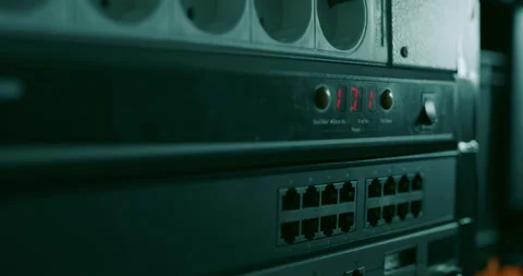 Technician presses the "turn off" button on a network switch Stock Footage 131016718