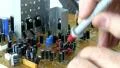 Technician probes circuit board; 2 HD Footage