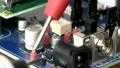 Technician probes circuit board; 4 HD Footage
