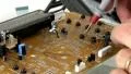 Technician probes circuit board HD Footage