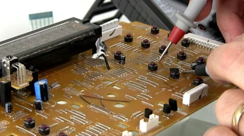 Technician probes circuit board Stock Footage 10588993