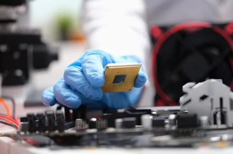 Technician put processor on computer motherboard socket 写真素材