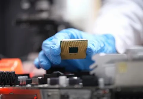 Technician puts processor on computer motherboard socket 写真素材