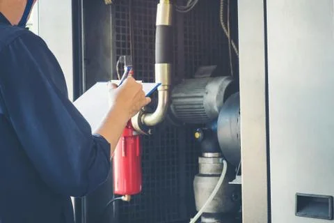 Technician is recording data Voltage or current in control panel of power p.. Stock Photos