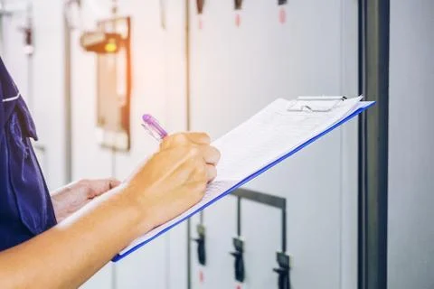 Technician is recording data Voltage or current in control panel of power pla Foto stock