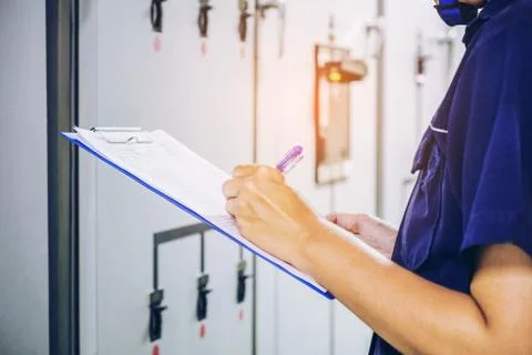 Technician is recording data Voltage or current in control panel of power pla Stock Photos