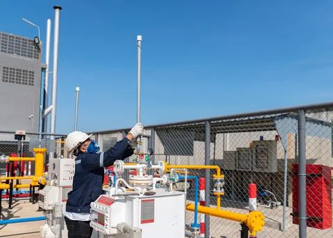 Technician remove blower pipe of safety valve on gas vaporizer machine Stock Photos