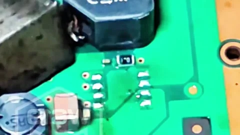 Technician Removing SMD Integrated Circuit from PCB with Heat Gun Stock Footage 333553004