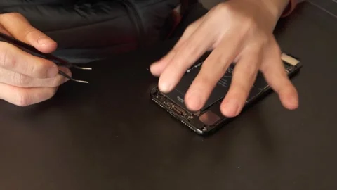 Technician repairing / assembling Iphone - 4K Timelapse Stock Footage 295004503