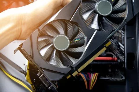 Technician repairing computer Change the graphics card in the computer. Stock Photos