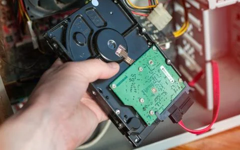 A technician repairing a computer with different tools. Computer support engi Stock Photos