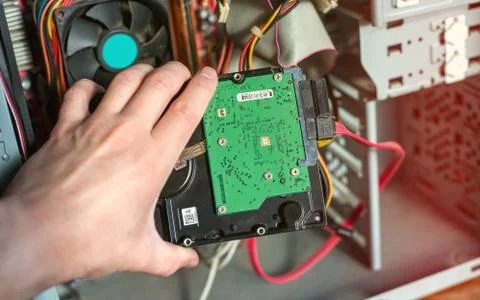 A technician repairing a computer with different tools. Computer support engi Foto stock