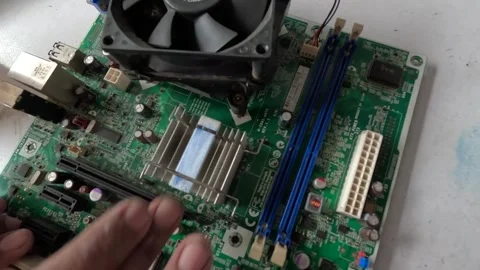 A technician is repairing a computer motherboard Stock Footage 247818228