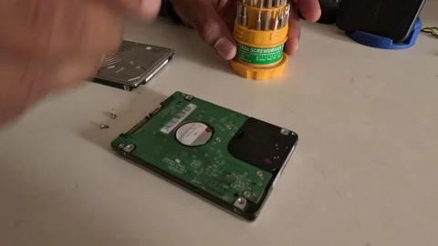 A technician is repairing a computer's hard disk Stock Footage 247817592