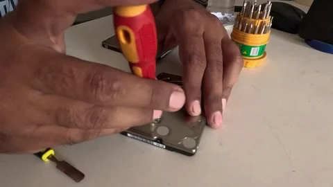 Technician is repairing a computer's hard disk Stock Footage 247817720