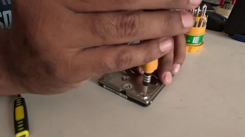 Technician is repairing a computer's hard disk Stock Footage 247817745