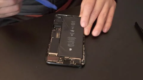 Technician repairing / disassembling Iphone - 4K Video stock 295004506