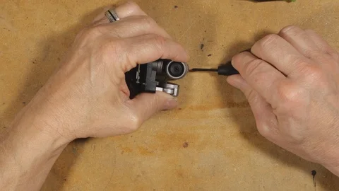 A technician repairing a drone camera Stock Footage 124320336