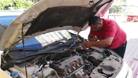 Technician is repairing the engine of the car Stock Footage 213489851