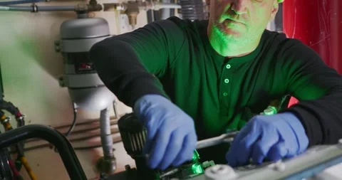 Technician Repairing Machinery in Engine Room Stock Footage 323737635