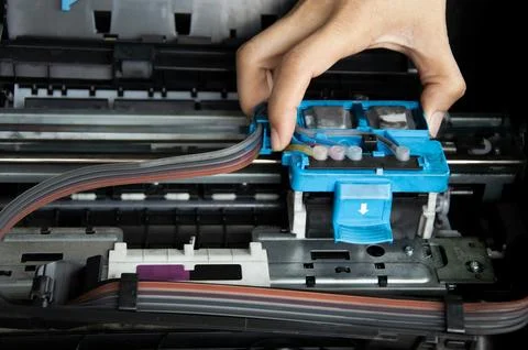 Technician repairing printer, fixing printer head Stock Photos