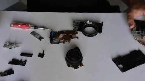 Technician repairs broken point and shoot camera in pieces time-lapse Stock Footage