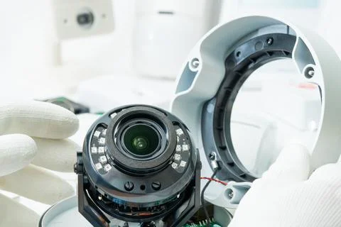 Technician repairs CCTV camera on the table. close-up Stock Photos