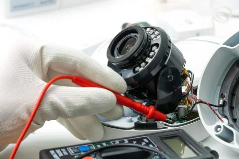 Technician repairs CCTV camera on the table.close-up Stock Photos