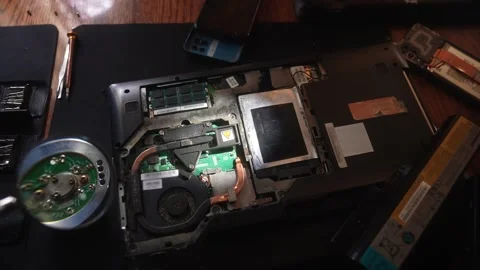 Technician Repairs Laptop Internal Components on Desk, showing components under Stock Footage 328865385