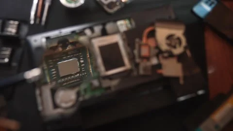 Technician Repairs Laptop Internal Components on Desk, showing components under Vídeo Stock 329581833