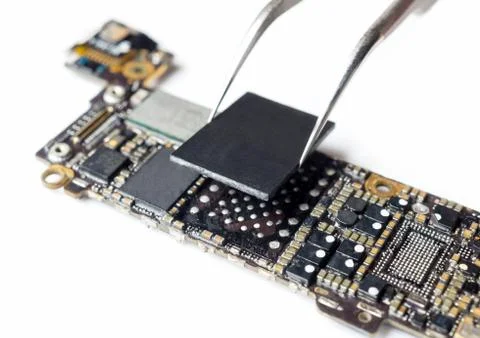 Technician replacing flash storage of smartphone motherboard Stock Photos