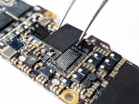 Technician replacing power IC of smartphone motherboard Stock Photos