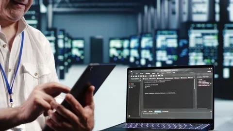 Technician running code in data center Stock Footage 249969766