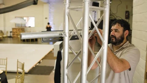 Technician Secures Truss Hardware for Television Mount Stock-Footage 343023007