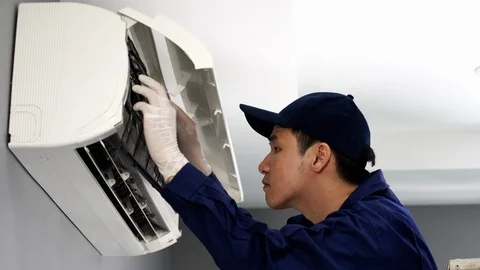 Technician service placing back clean filter into air conditioner Stock Footage 115456007
