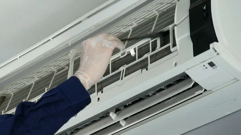 Technician service using brush to cleaning the air conditioner indoors Stock-Footage 124592259
