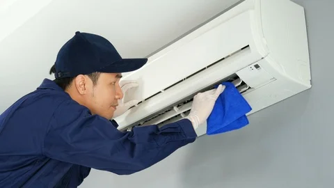 Technician service using fabric to cleaning the air conditioner indoors Stock Footage 123901684