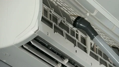 Technician service using vacuum cleaner to cleaning the air conditioner Stock Footage 134641370